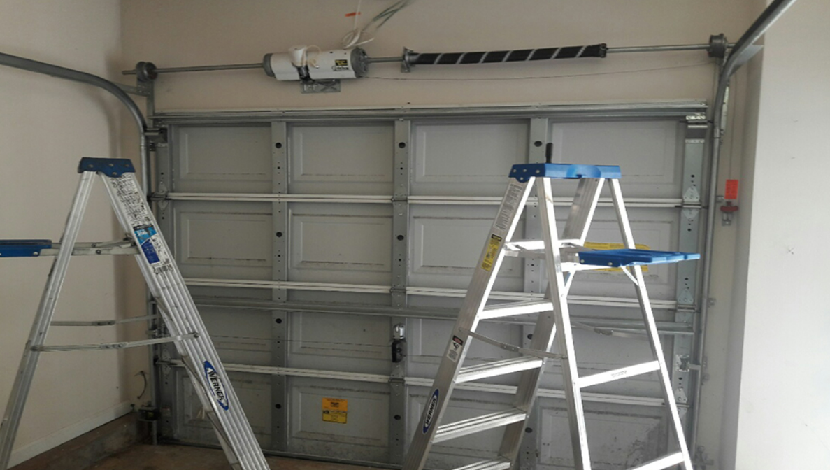 Technician performing garage door repair in Lewis Center to fix broken springs and openers.