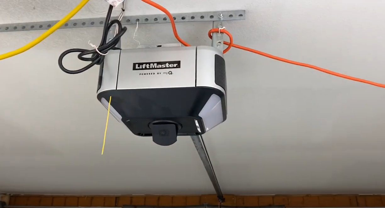 Technician performing garage door opener repair at a residential home in Lewis Center, ensuring smooth functionality and safety for homeowners.