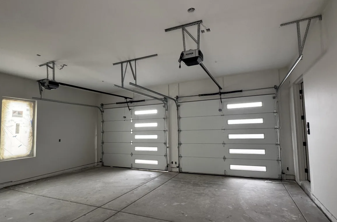 Certified technician installing a new residential modern garage door in Sunbury, Ohio